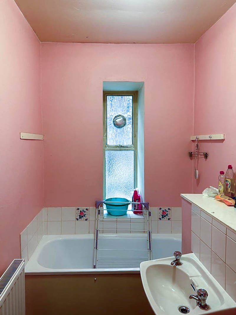 The bath below the window, before the works