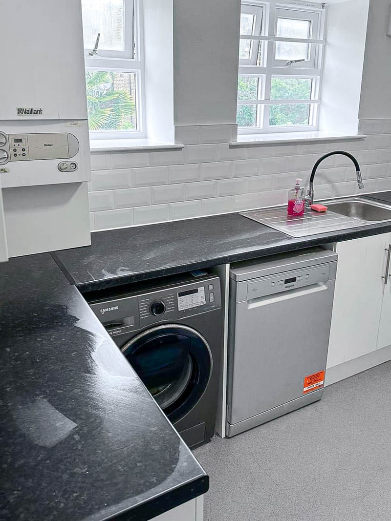 The same kitchen, the sink and appliance run, after the works