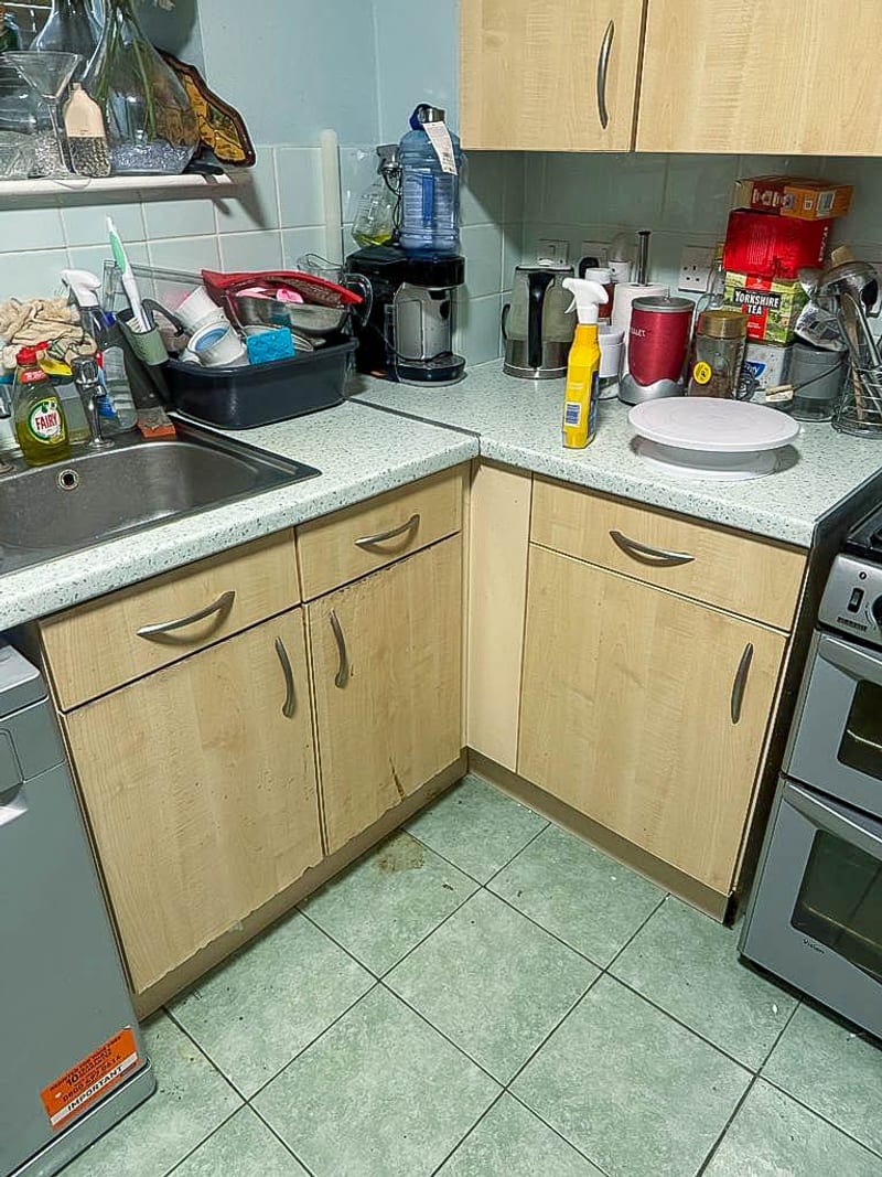 The same kitchen, the sink and appliance run, before the works