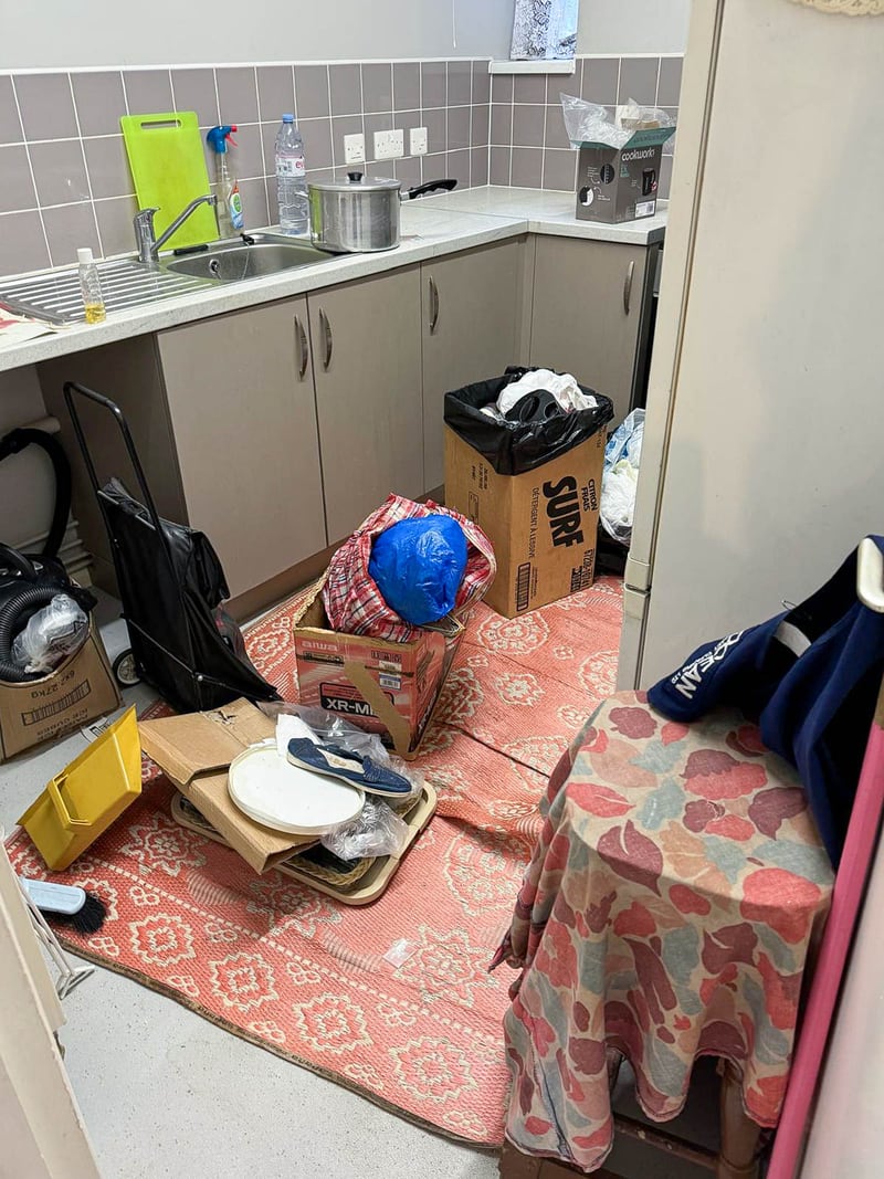 The kitchen of a social housing void, before the works